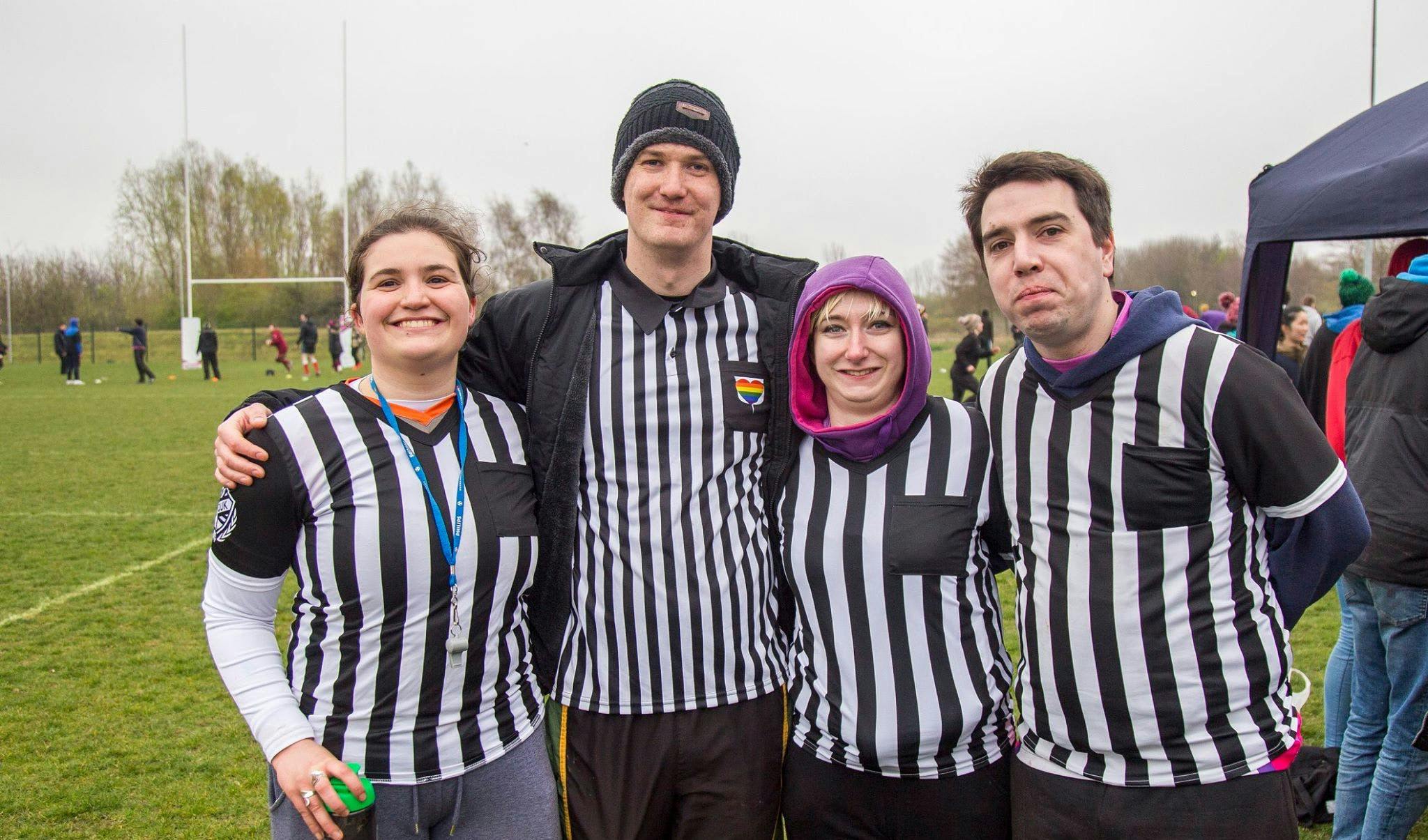 Refs pose together before a match, all wearing their referee shirts