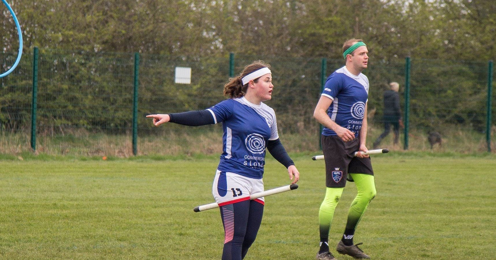 Bex Lowe points to something off-pitch while chasing during a match
